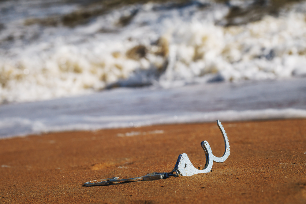 Concept,of,freedom:,open,handcuffs,on,sand,lying,on,a