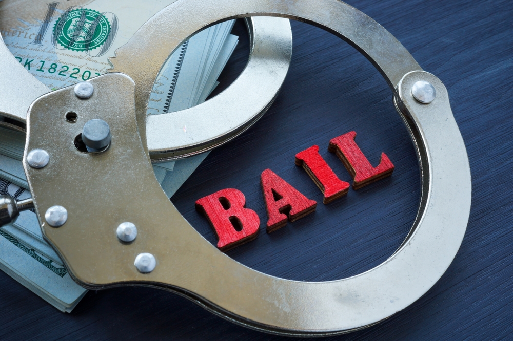 Bail,bonds,concept.,the,handcuffs,are,on,the,dollars.
